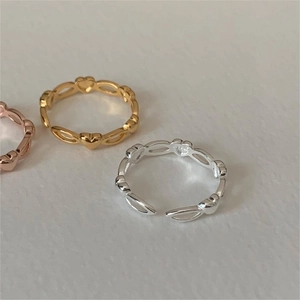 Three minimalist heart-shaped hollow rings in gold, silver and rose gold finishes