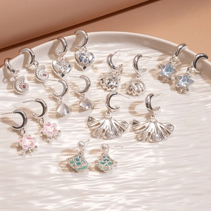 Detail of silver earrings with crystals and pearls in Ginkgo and Star shapes