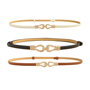 Three skinny women's belts in cream, black, and brown with gold twisted metal buckles