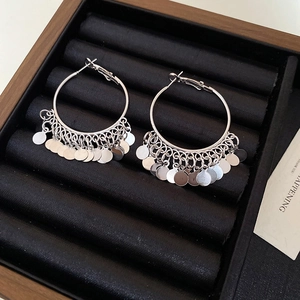 Detail view of silver layered hoop earrings with sequins in a luxury black jewelry box