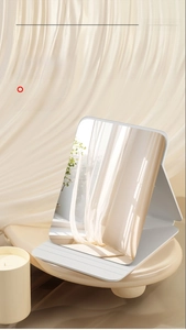 Detail of a portable folding makeup mirror with sleek white frame on a stylish display stand