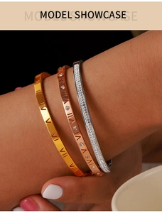 Detailed view of three-piece titanium steel bracelets with Roman numerals and zircons