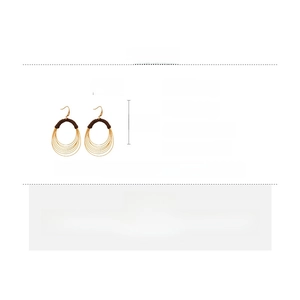 Detail view of multi-layer gold round earrings with brown thread wrap and size specs