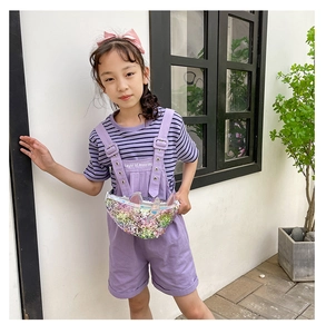 Detail view of a sequined unicorn waist bag for girls worn with a stylish outfit