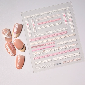 Macro view showing 3D embossed white and pink lace nail stickers with bow and heart motifs