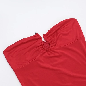 Detail shot of the red strapless dress showing the ruched neckline and zipper