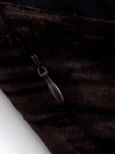Macro shot of invisible zipper detail on dark striped corduroy tassel sleeveless dress