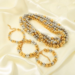 Elegant multi-layered gold and silver beaded necklace and bracelet set on silk