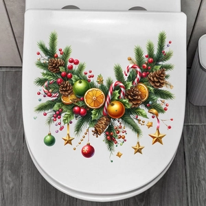 Detail view of festive Christmas pine and red berry wall decals on a white background