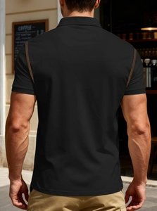 Detail of brown contrast stitching on the shoulder of a black men's knit Polo shirt