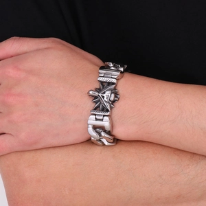 Close-up of retro silver wolf head stainless steel bracelet worn on a male wrist