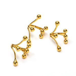 Detailed view of three-piece 18k gold plated titanium steel rings with bead accents