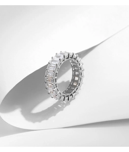 Detailed close-up of emerald-cut sparkling gemstones in a sterling silver eternity band