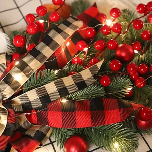 Christmas teardrop swag with red berries green pine needles and LED lights decoration