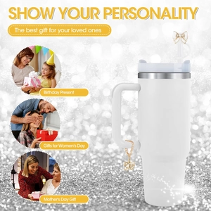 Detail view of white tumbler with rhinestone bow straw cover and butterfly pendant accessory
