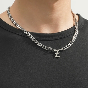 Close-up of silver Cuban chain necklace featuring a gothic letter Z pendant on a model