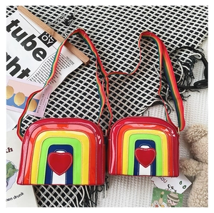 Detailed close-up of colorful rainbow heart-shaped crossbody bags in two different sizes