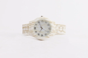 Detailed view of women's analog watch featuring beige wood grain texture on band and case