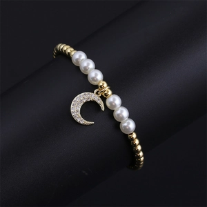 Elegant gold plated bracelet with white pearls and a zircon-studded moon pendant