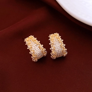 Detail of 14K gold plated C-shaped earrings with shimmering micro-pave cubic zirconia