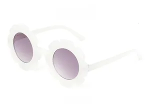Side view of white flower shaped kids sunglasses with purple gradient lenses