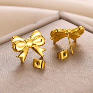 Macro shot of 18K gold plated bow earrings with polished finish and butterfly backings