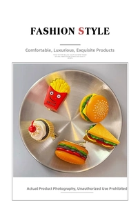 Detailed view of novelty food-shaped hair clips including burger and fries on a tray