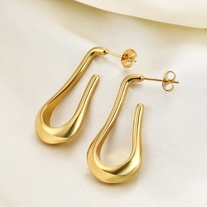 Polished 14K gold 304 stainless steel teardrop hollow earrings for women on white silk
