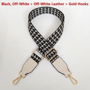 Close-up of black and white houndstooth bag strap with gold metal hooks and leather