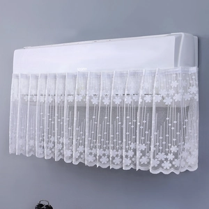 Detail of white lace air conditioner cover with floral mesh and wavy hem