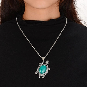 Bohemian silver turtle pendant necklace with turquoise stone inlay on a braided chain