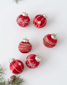 Detail of red silk texture Christmas balls with snowflake and pearl ornaments