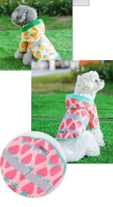 Detail of waterproof dog raincoat with reflective strips and cute fruit prints