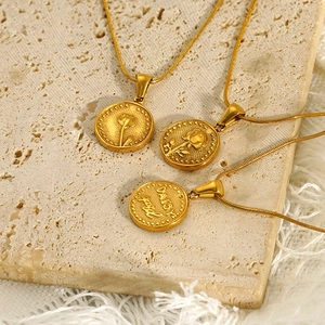 Elegant gold daisy flower coin pendant necklace on natural stone surface for women