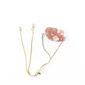 Adjustable gold chain bracelet with irregular raw pink crystal stone and cubic zirconia charms
