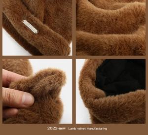 Detail of brown faux mink fur hat with golden logo plate and warm black lining