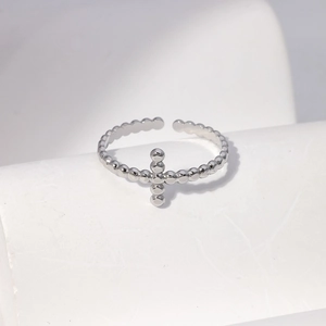 Detailed view of silver stainless steel bead ring featuring a minimalist cross design