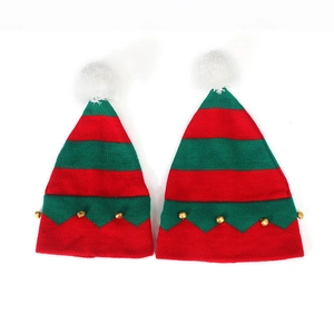 Matching Christmas knit hats with red and green stripes, fluffy pom poms and bells