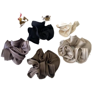 Set of minimalist satin scrunchies in neutral earth tones like cream and brown