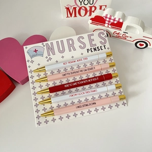Close-up of 5-piece nurse themed pen set with funny phrases and gold-tone metal clips