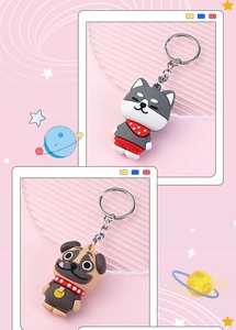 Close-up of cute PVC husky and pug dog cartoon keychains with metal rings
