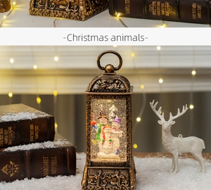 Detail of vintage bronze Christmas lantern with snowmen family and warm glowing lights