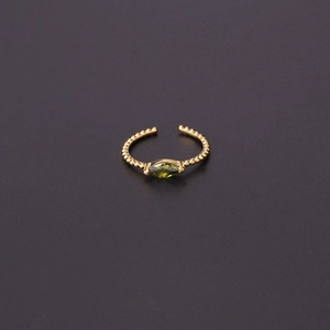 Detail of green marquise-cut stone and beaded texture on adjustable golden ring