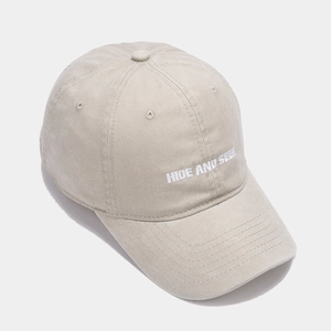 Light khaki cotton baseball cap with HIDE AND SEEK embroidery and vintage washed texture