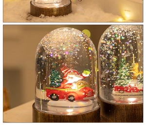 Macro shot of a Christmas snow globe featuring Santa Claus in a car with glitter