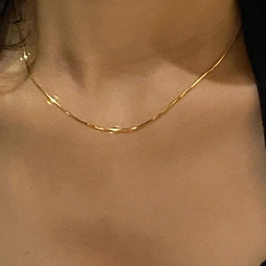 Minimalist 18K gold snake chain necklace made of stainless steel shown on neck
