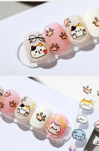 Detail of 5D embossed nail stickers featuring cute cartoon cats and smile text