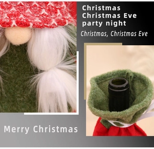 Detail of knitted Christmas gnome wine bottle cover with plush beard and festive texture