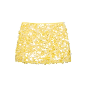 Detailed close-up of vibrant yellow sequins on the mini skirt showing texture and shine
