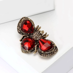 Exquisite insect brooch with three large red faceted gemstones and champagne rhinestones